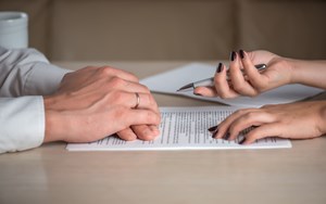 two people review paperwork together