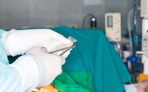 a surgeon prepares to insert mesh implant