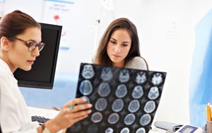 two medical professions look at brain scan