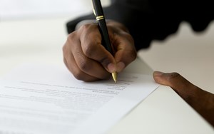 a person signs an important document